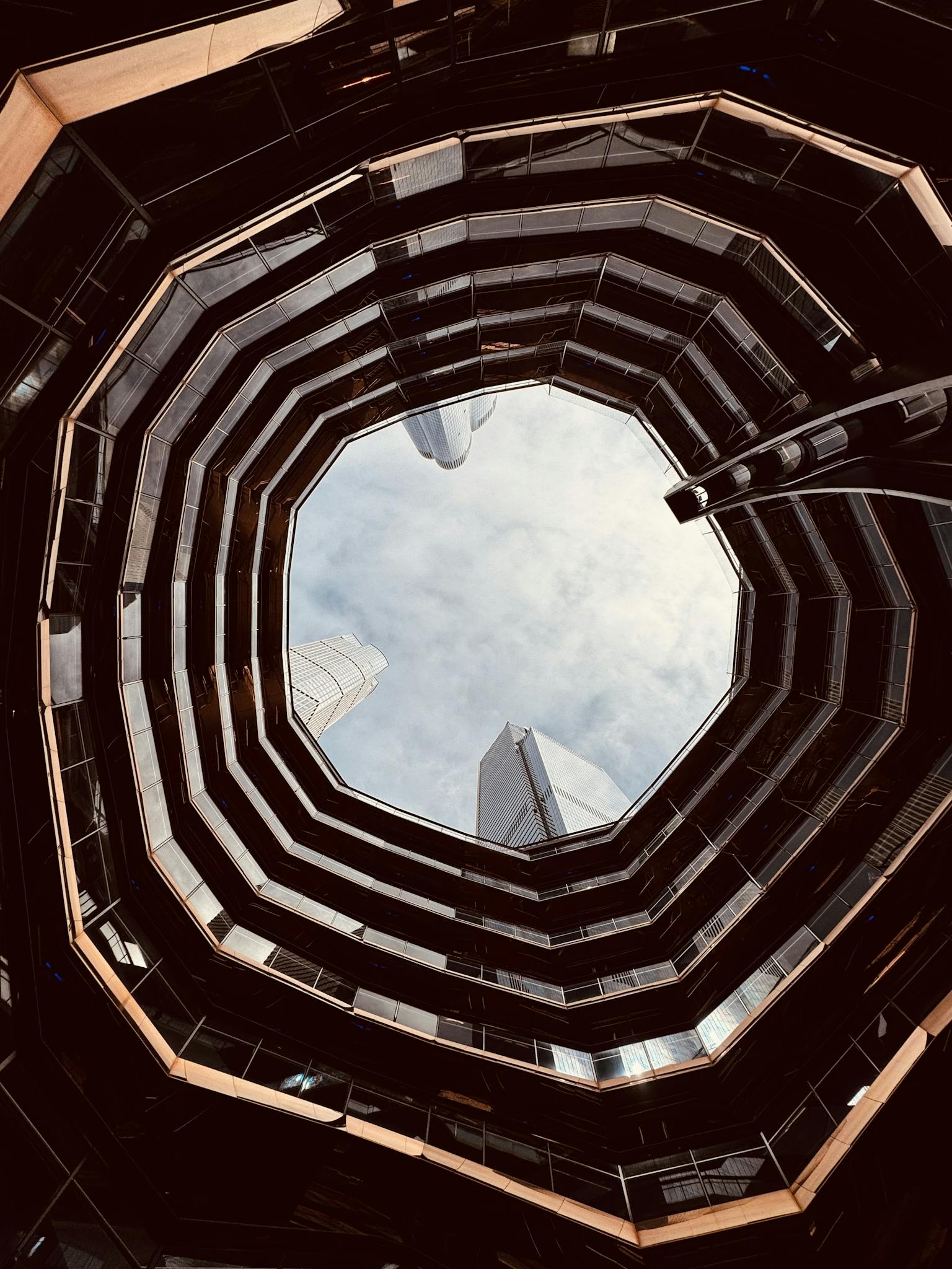 Perspective view of a modern architectural structure looking up through a skylight.