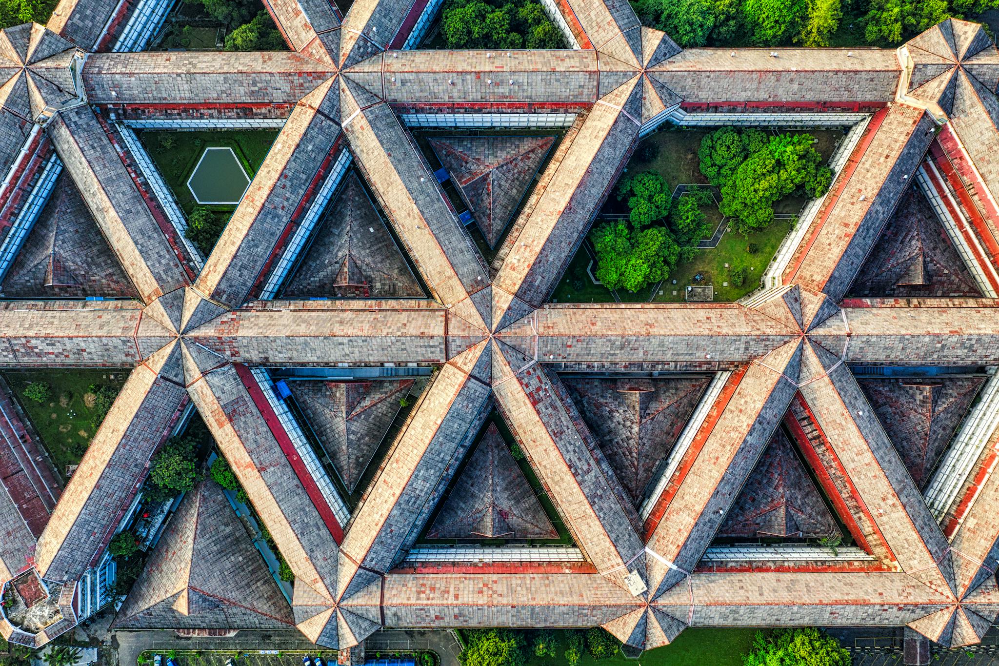 Stunning aerial view capturing geometric architectural patterns amidst lush greenery in West Java, Indonesia.